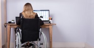 woman looking through best disability insurance companies on laptop